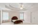 Bedroom features a tray ceiling, neutral walls, carpet, and double-door closet at 3175 Lake Seminole Pl, Buford, GA 30519