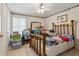 Bedroom with ceiling fan and full wooden bed frame at 3175 Lake Seminole Pl, Buford, GA 30519