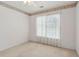 Bedroom features light neutral walls, ceiling fan, and large window with lots of light at 3175 Lake Seminole Pl, Buford, GA 30519