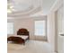 Bedroom features a tray ceiling, neutral walls, carpet, and one door at 3175 Lake Seminole Pl, Buford, GA 30519