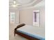 Bright bedroom featuring a tray ceiling and doorway to another room at 3175 Lake Seminole Pl, Buford, GA 30519