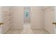 Walk-in closet featuring built-in wire shelving and neutral carpeting at 3175 Lake Seminole Pl, Buford, GA 30519