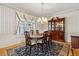 Traditional dining room with a chandelier, striped wallpaper, and wooden furniture at 3175 Lake Seminole Pl, Buford, GA 30519