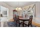 Charming dining room with a chandelier, hardwood floors, and decorative window treatment at 3175 Lake Seminole Pl, Buford, GA 30519
