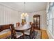 Formal dining room with hardwood floors, traditional furniture, and a decorative chandelier at 3175 Lake Seminole Pl, Buford, GA 30519