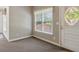 Entryway featuring a decorative stained glass window and neutral carpeting at 3175 Lake Seminole Pl, Buford, GA 30519
