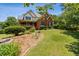 Two-story brick home with inviting front porch, landscaped yard, and mature trees at 3175 Lake Seminole Pl, Buford, GA 30519