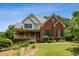 Beautiful two-story home featuring a brick facade, covered porch, and manicured landscaping at 3175 Lake Seminole Pl, Buford, GA 30519