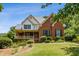 Beautiful two-story home with brick exterior, green shutters, and a welcoming front porch at 3175 Lake Seminole Pl, Buford, GA 30519