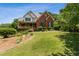 Two-story home with a brick facade, covered porch, and well-maintained landscaping on a sunny day at 3175 Lake Seminole Pl, Buford, GA 30519