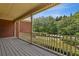 Inviting front porch with a classic railing and views of the landscaped yard and mature trees at 3175 Lake Seminole Pl, Buford, GA 30519