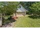 Detached garage in a lush, wooded setting provides a great additional space at 3175 Lake Seminole Pl, Buford, GA 30519