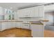 Clean kitchen with white cabinets, hardwood floors, and modern appliances at 3175 Lake Seminole Pl, Buford, GA 30519