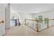 Upstairs landing area with wood railing and lots of natural light from the arched windows at 3175 Lake Seminole Pl, Buford, GA 30519