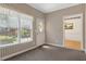 Cozy living room featuring a large window, patterned wallpaper, and a glimpse into an adjacent room at 3175 Lake Seminole Pl, Buford, GA 30519