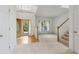 Bright living room with hardwood floors at the entry and a staircase to the second level at 3175 Lake Seminole Pl, Buford, GA 30519
