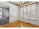 Empty living room with plantation shutters, and hardwood floors at 3175 Lake Seminole Pl, Buford, GA 30519
