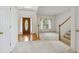 Bright living room with hardwood floors at the entry and a staircase to the second level at 3175 Lake Seminole Pl, Buford, GA 30519