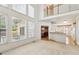 Bright living room with ample natural light and an open view to the dining area at 3175 Lake Seminole Pl, Buford, GA 30519