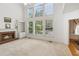Bright and inviting living room with a fireplace, built-in shelving, and large windows at 3175 Lake Seminole Pl, Buford, GA 30519