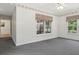Sunroom with gray carpet, patterned wallpaper, windows with awnings and a doorway to another room at 3175 Lake Seminole Pl, Buford, GA 30519