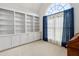 Home office featuring built-in shelving, a window with curtains, and natural light at 3175 Lake Seminole Pl, Buford, GA 30519