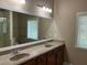 Bathroom featuring double sinks, large mirror, and vanity at 407 Aerif Pl, Woodstock, GA 30188