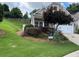 Well-maintained home with a lush, green lawn, and tidy landscaping at 407 Aerif Pl, Woodstock, GA 30188