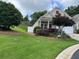 Well-maintained home with a lush, green lawn, and tidy landscaping at 407 Aerif Pl, Woodstock, GA 30188