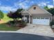 Charming single-Gathering home with a two-car garage, manicured lawn, and colorful landscaping at 407 Aerif Pl, Woodstock, GA 30188