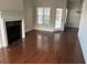 Bright living room features wood floors, fireplace, and views to the exterior at 407 Aerif Pl, Woodstock, GA 30188