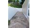 This backyard has a white fence surrounding the stone ground and grassy hills at 407 Aerif Place Pl, Woodstock, GA 30188