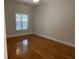 Bright bedroom featuring hardwood floors and a window providing natural light at 407 Aerif Place Pl, Woodstock, GA 30188