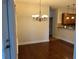 Open concept dining room with hardwood flooring and chandelier at 407 Aerif Place Pl, Woodstock, GA 30188