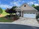 Inviting single-Gathering home with beautiful landscaping, a covered porch, and attached two-car garage at 407 Aerif Place Pl, Woodstock, GA 30188