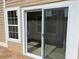 An exterior view showcasing the sliding glass door entrance to a sunroom at 407 Aerif Place Pl, Woodstock, GA 30188