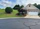 Charming single Gathering home with a well-manicured lawn, flowers, and a two-car garage at 407 Aerif Place Pl, Woodstock, GA 30188