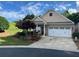 Charming single-story home featuring manicured landscaping and a two-car garage at 407 Aerif Place Pl, Woodstock, GA 30188