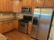 Well-equipped kitchen featuring stainless steel appliances and wooden cabinetry at 407 Aerif Place Pl, Woodstock, GA 30188