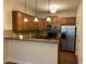 Kitchen featuring stainless steel appliances, granite countertops, and wooden cabinetry at 407 Aerif Place Pl, Woodstock, GA 30188