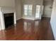 Elegant living room with hardwood floors, a fireplace, and lots of natural light at 407 Aerif Place Pl, Woodstock, GA 30188