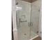 Modern glass shower featuring marble tiling, rainfall shower head, and built-in shelving at 407 Aerif Place Pl, Woodstock, GA 30188