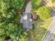 Aerial shot showcases the home's roof, surrounding trees, and a winding driveway at 1801 Summerview Ct, Woodstock, GA 30189