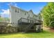 Back exterior view with a spacious deck, stairs to the yard and gray siding at 1801 Summerview Ct, Woodstock, GA 30189