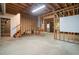 Unfinished basement with concrete floor, exposed beams, open staircase and access to backyard at 1801 Summerview Ct, Woodstock, GA 30189