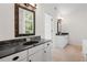Bathroom featuring double vanities with granite countertops and decorative mirrors with natural light at 1801 Summerview Ct, Woodstock, GA 30189