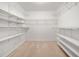 Spacious walk-in closet with carpet and multiple levels of shelving, perfect for organizing belongings at 1801 Summerview Ct, Woodstock, GA 30189