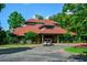 Clubhouse with a red tile roof and golf cart parking at the entrance at 1801 Summerview Ct, Woodstock, GA 30189