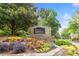 Stone entrance to the 'Eagle Watch' community with colorful floral arrangements at 1801 Summerview Ct, Woodstock, GA 30189
