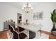 Contemporary dining room with modern chandelier, hardwood floors, and stylish decor provides an elegant space at 1801 Summerview Ct, Woodstock, GA 30189